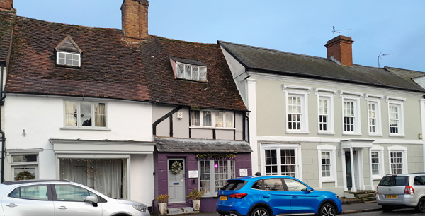 Shops and grey-painted house